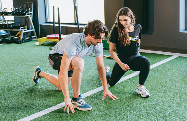 coach working with client on a specific exercise